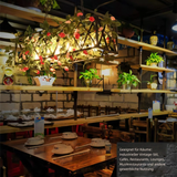 Industrielle Pendelleuchte mit Eisenrahmen und floralen Akzenten